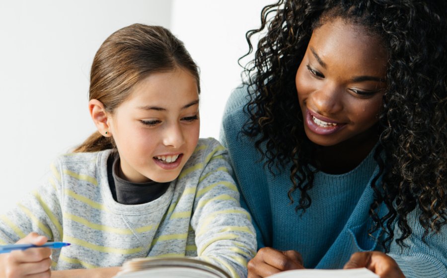 A tutor helping a learner with schoolwork